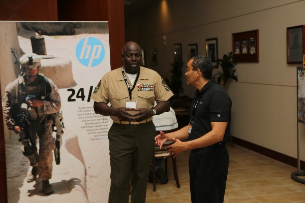 At TechNet in September, Master Gunnery Sgt. Arthur Allen III, USMC, communications chief, III Marine Expeditionary Force and the chapter's first enlisted president, interacts with Moriyoshi Nixon, a corporate representative of WESCO/CSC.